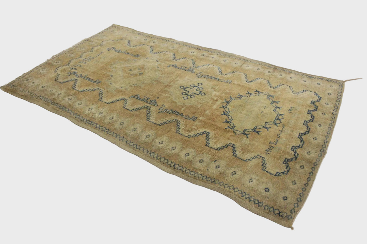 Decorative rug with intricate patterns on a white floor