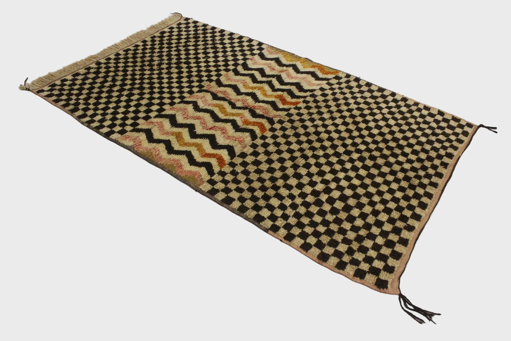 Woven mat with geometric pattern on a white background