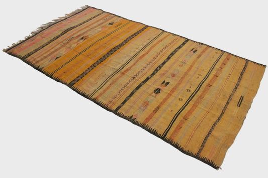 Woven rug with striped pattern on a plain background