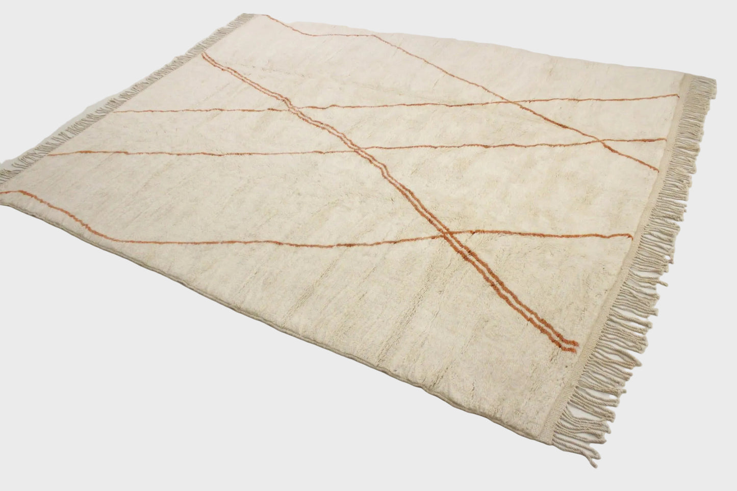 Beige rug with brown lines and fringes on a light gray background