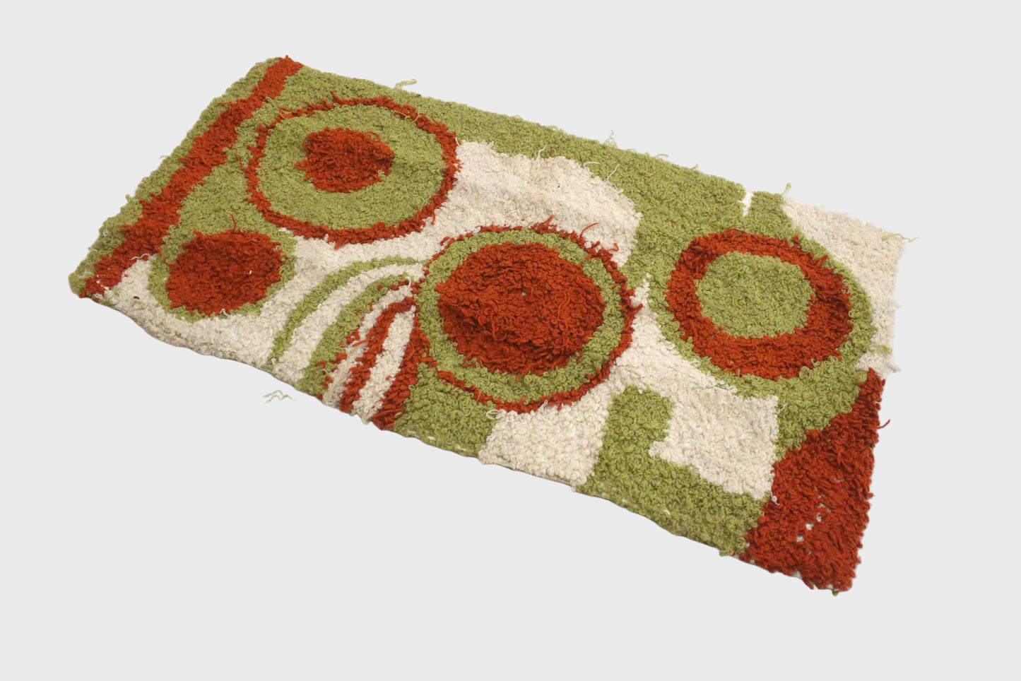 Decorative doormat with circular patterns on a white background